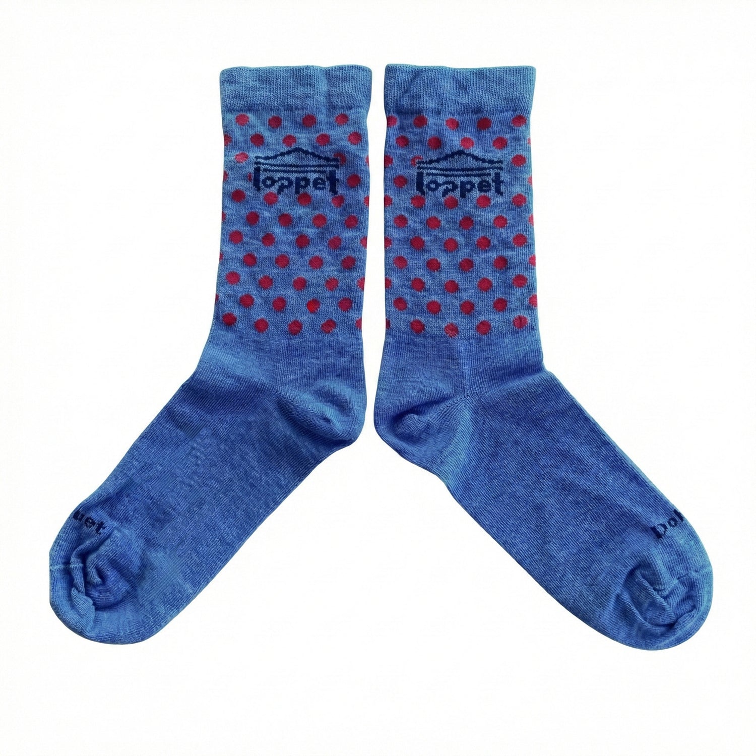 Pair of blue socks with red polka dots and 'loppet' branding on a white background